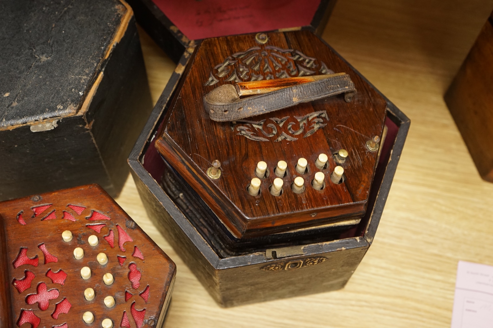 Two cased concertinas; one in mahogany with original paper label for Lachenal & Co., London, the other in rosewood (a.f.)